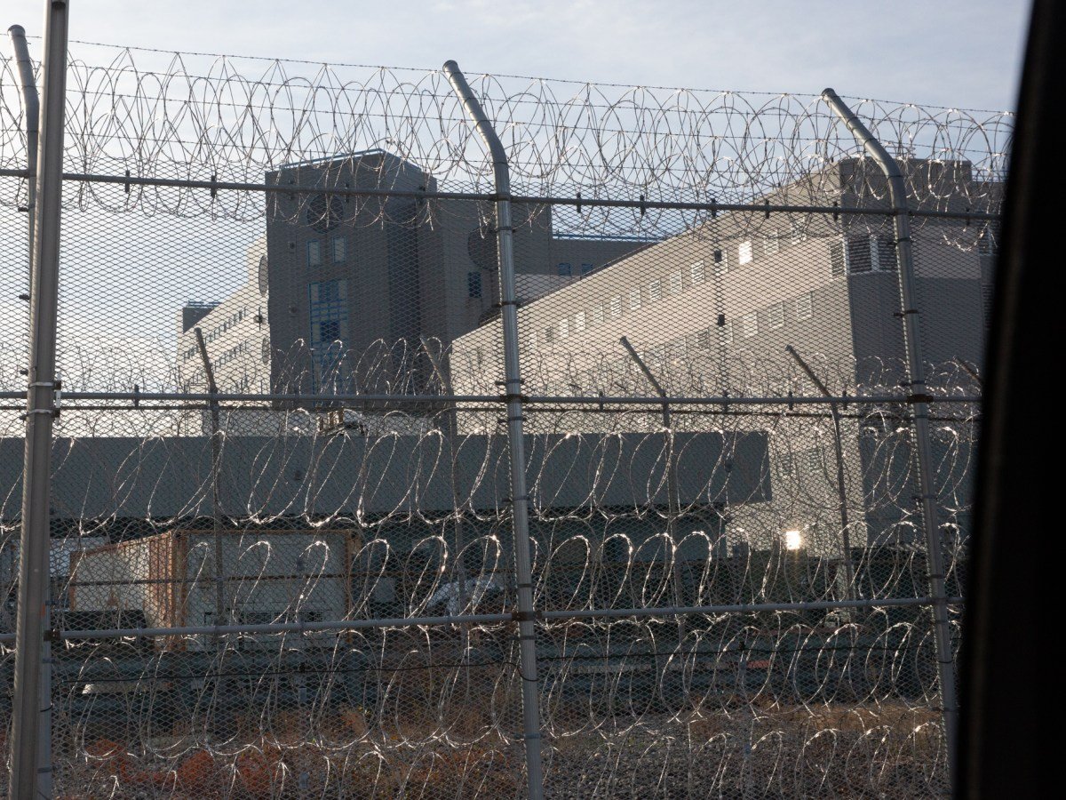 Barbed wire surrounds a jail facility on Rikers Island,