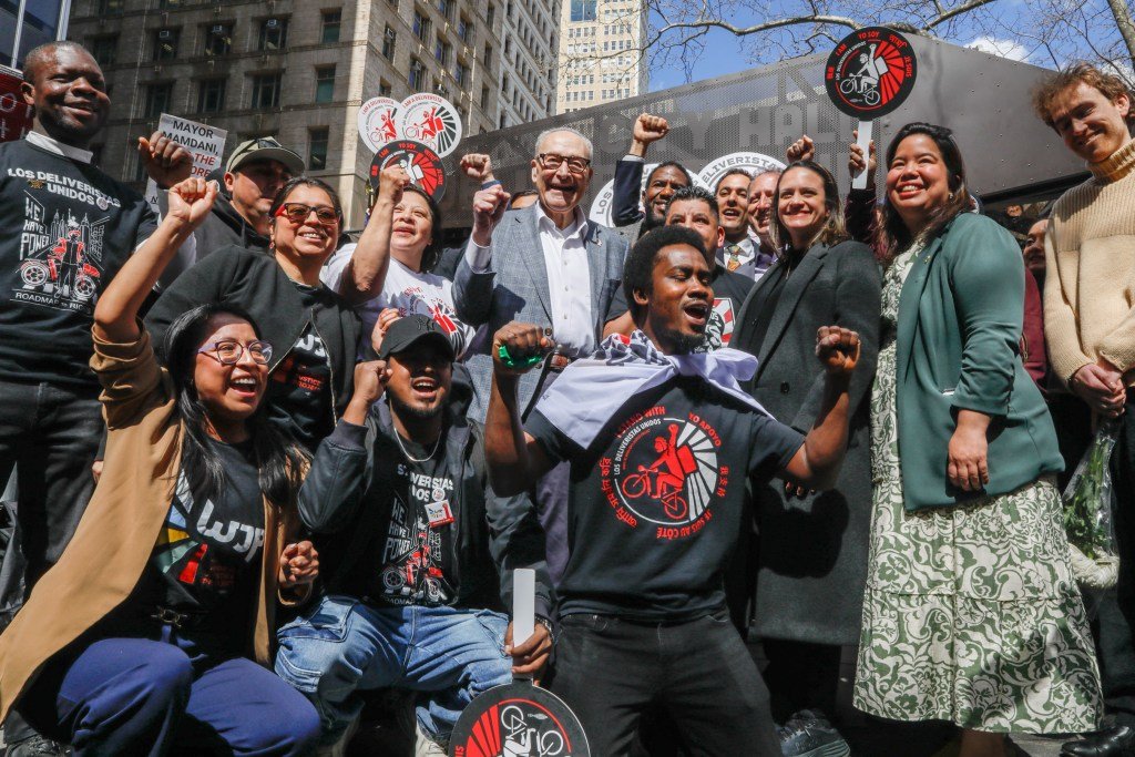 Delivery workers celebrate with Sen. Chuck Schumer (D-Manhattan) the opening of a Deliverista Hub at City Hall Park,