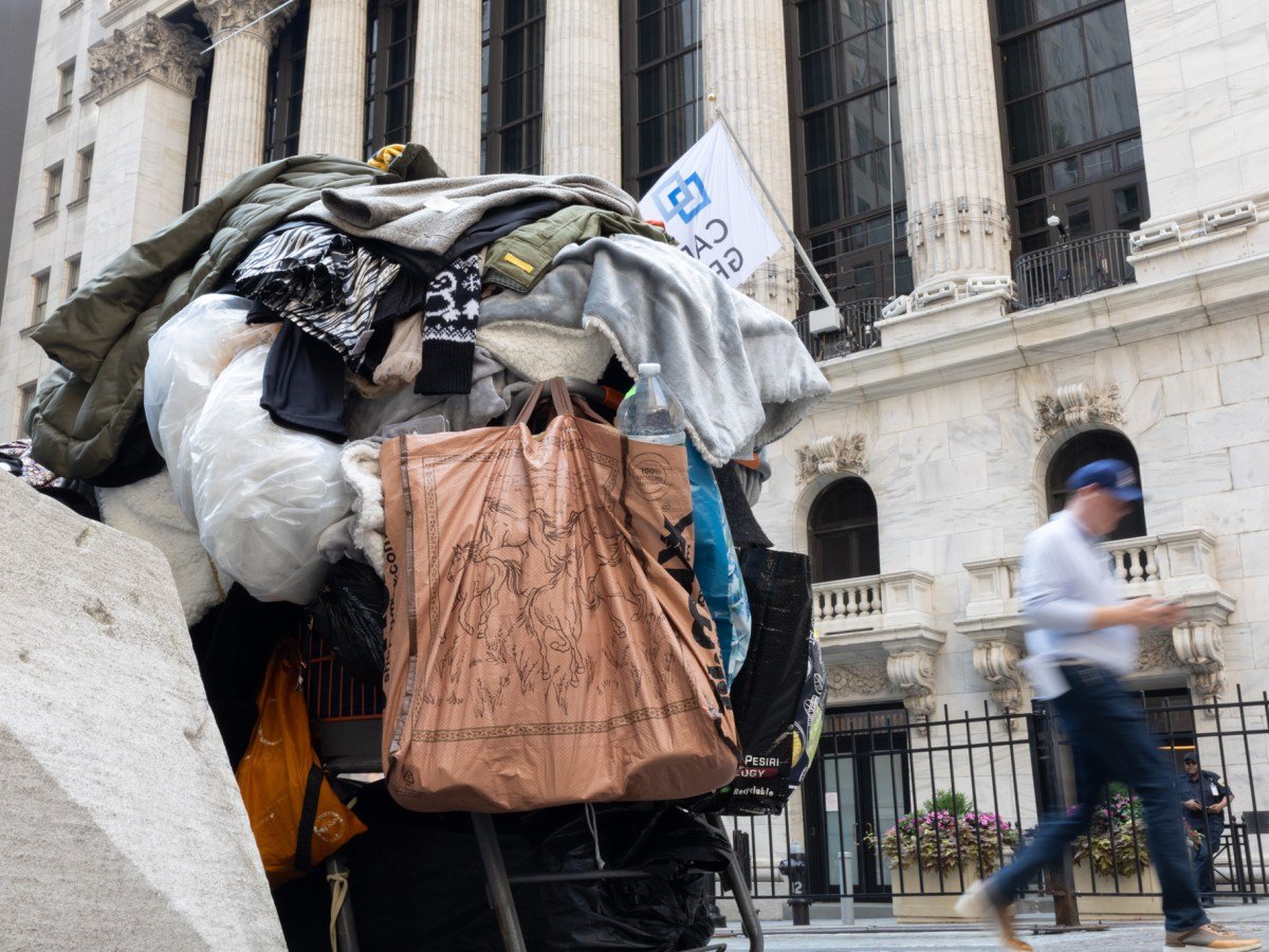 A homeless person parked their belongings in front of the Stock Exchange,