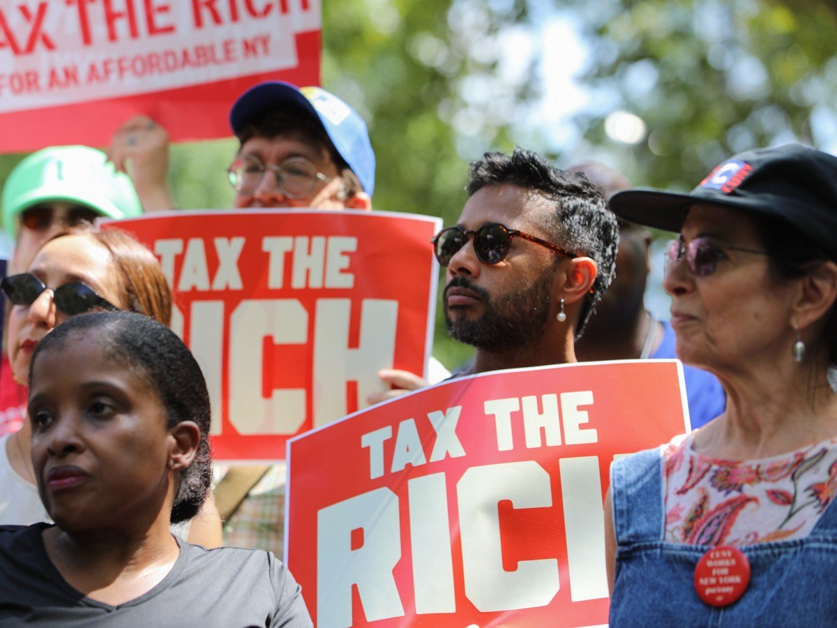 Progressive advocates rally in front of City Hall ahead of a hearing on the new pied-à-terre tax,