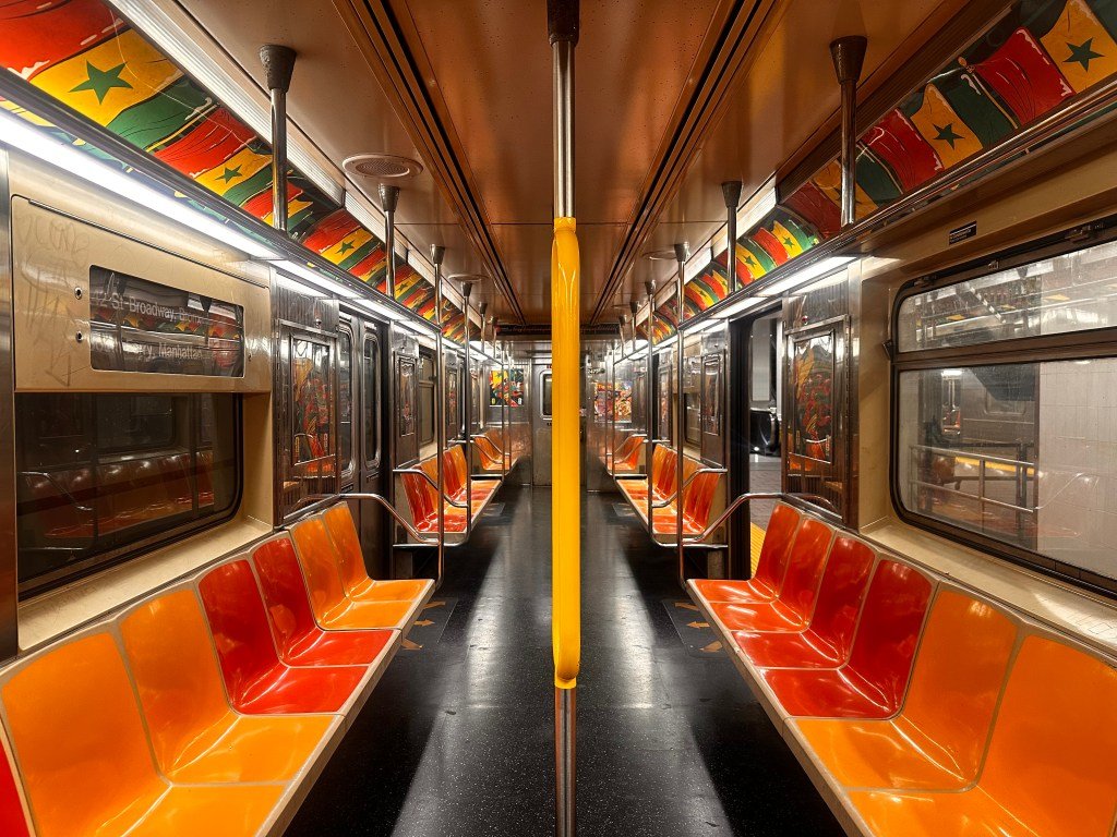 Orange seats ennoble an uptown 1 train at South Ferry, June 16, 2026.